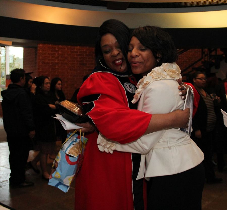 Dr. Sheila celebrating in her doctoral gown